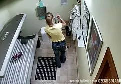 Een gebruind erotisch films meisje straalt op haar borst en masturbeert met een mooie